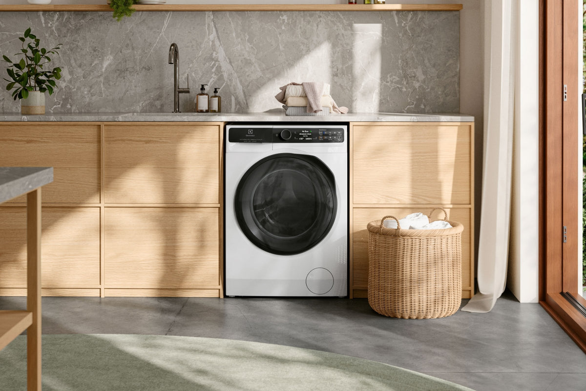 Electrolux vaske-tørremaskine i et bryggers med kurv og store vinduer