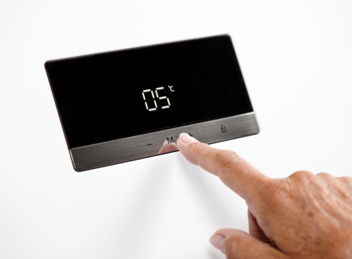 Finger trykker på TouchControl-displayet på døren af et Gram køleskab